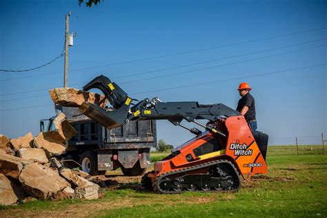 ride behind skid steer|ditch witch stand on skid steer.